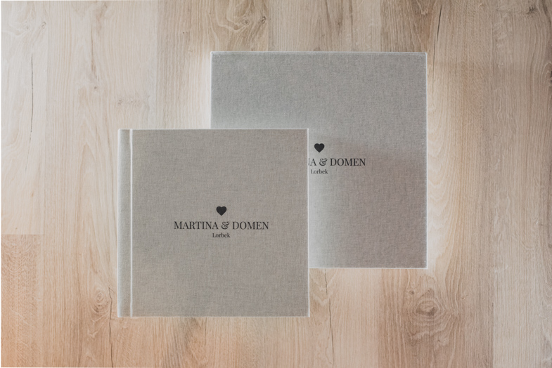 Photo of a wedding photo book with inscribed names of newlyweds.