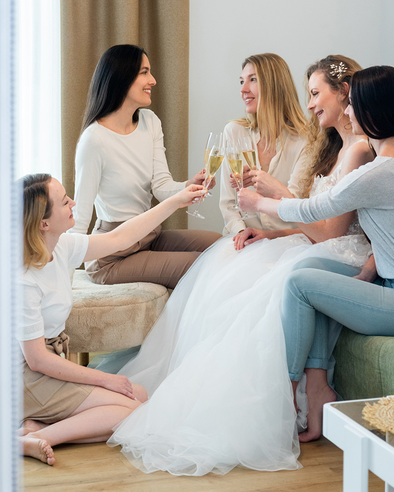 The bride toasts with sparkling wine with her friends.