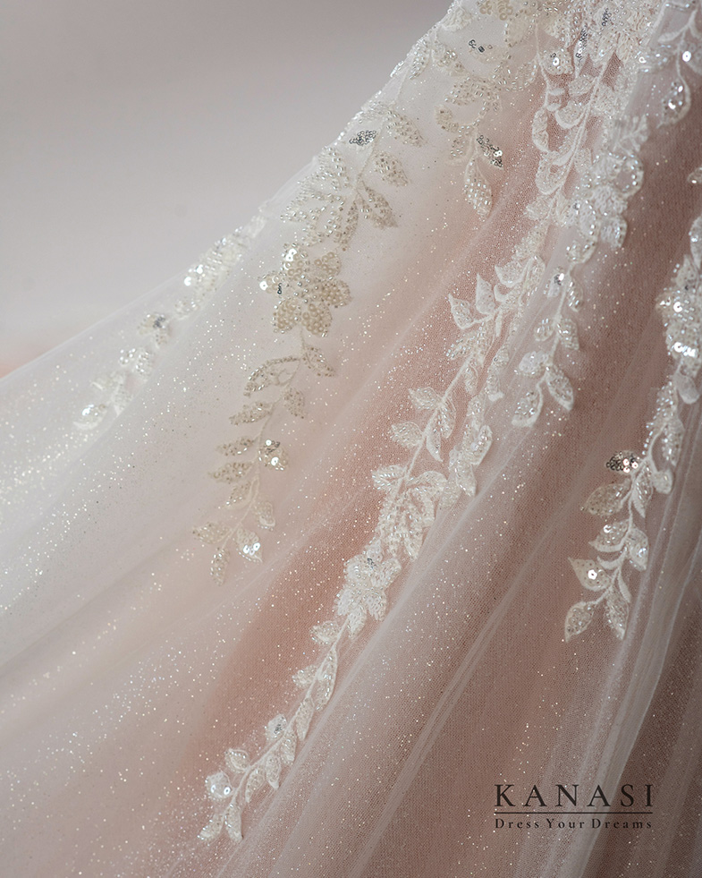 Detail of a wedding dress with lace and sequins.