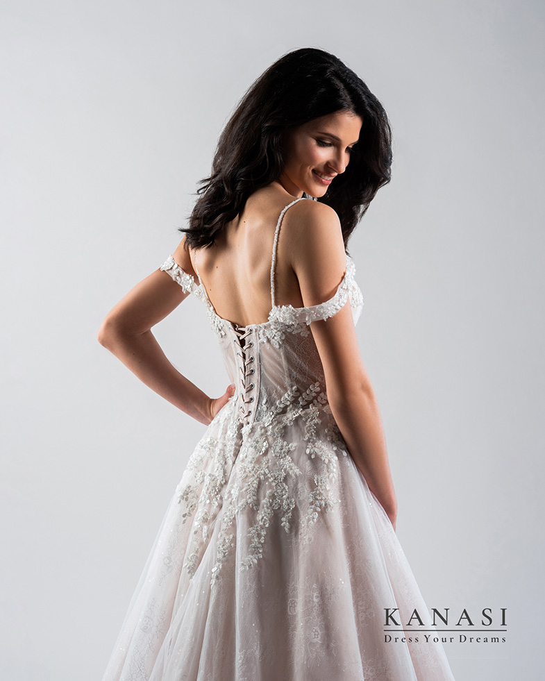 Bride in a wedding dress against a white background.